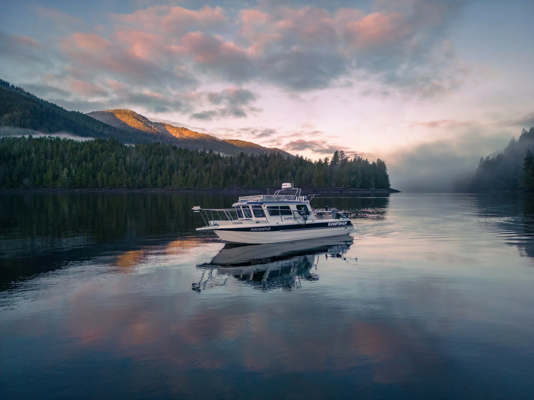 DC Charters boat in a sheltered north coast bay at sunset